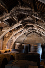 Old oak barrels for aging of natural sweet red grand cru wine Banyuls fortified dessert wine from old vines from slopes of the Catalan Pyrenees in Roussillon, France.