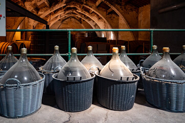 Dame Jeanne or demijohn glass jars for aging of natural sweet red grand cru wine Banyuls fortified...