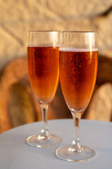 Summer vacation on Mediterranean sea, drinking cold rose champagne, cava sparkling wine in glass in sunlights, Collioure, Occitanie, South of France, tourists destination
