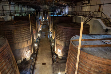 Old oak barrels for aging of natural sweet red grand cru wine Banyuls fortified dessert wine from old vines from slopes of the Catalan Pyrenees in Roussillon, France.
