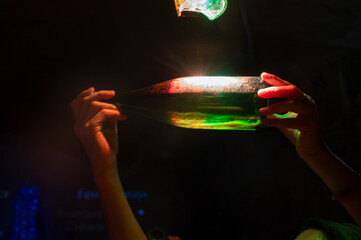 Sediment check in champagne bottle, dead yeast cells during secondary fermentation, traditional method of production of cremant, blanquette sparkling wine Limoux, Occitania, France