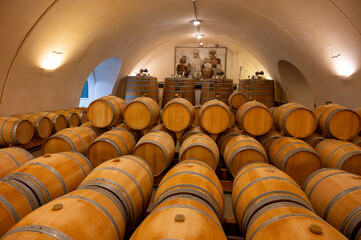 Visit of undergroud caves witn wine barrels in Cahors wine production area, red malbec wines, wine tasting in chateau, France