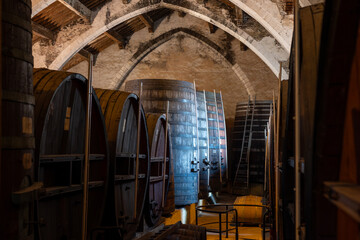 Old oak barrels for aging of natural sweet red grand cru wine Banyuls fortified dessert wine from...