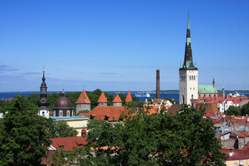 Estonia, Tallinn Historical centre. A church spire and towers of the medieval city wall. Panoramic view of the Old Town.