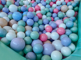 Imagine a vibrant ball pit that is generously filled with an array of colorful balls in various shades, creating a playful and inviting atmosphere that beckons everyone to join in