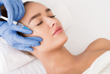 Beauty procedure. Woman receiving hyaluronic acid injection in spa salon