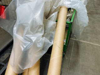 A plastic bag is being wrapped around two cardboard tubes for the purpose of protection and proper...