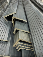 Metal angles, designed for construction, are neatly stacked for easy access and quick retrieval,...