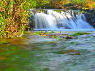 Water cycle: Waterfall of the São Vicente stream, Fragoso, among typical autumn vegetation