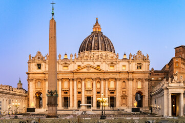 An iconic view of St. Peter's Basilica and the Vatican Obelisk in St. Peter's Square, Rome, at a beautiful blue hour. Morning colors add magic to the scenery and give image another dimension.