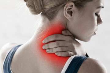 Professional athlete suffering from sports injury, feeling neck pain on white background