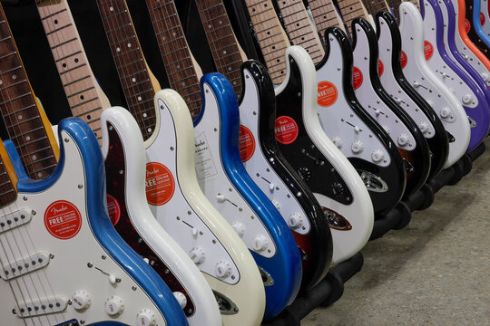 Fender Stratocaster guitar display at a music store. Strats are world renowned for their distinctive clean sound.