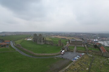 Whitby harbor town aerial panorama in England with Gothic cathedral on the hill and sea port view, concept of tourism and historic architecture