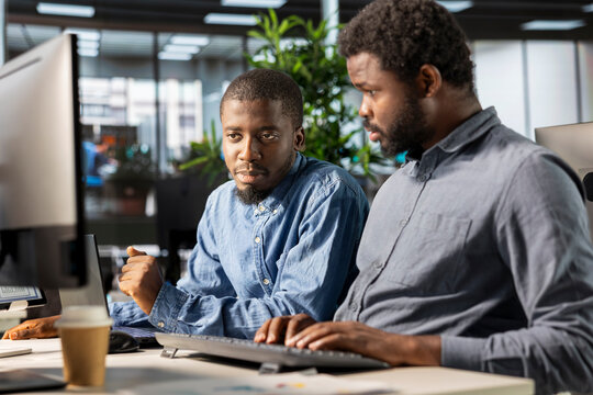 General manager working closely with a team member on planning business tasks, setting company goals and aligning organizational strategies with measurable outcomes for sustainable growth.