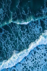 Aerial View of Crashing Ocean Waves and Foam Patterns