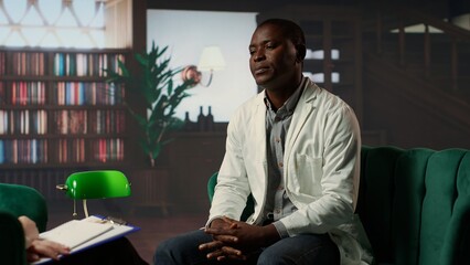 Professional counselor in therapy session with black medic experiencing trauma after losing...