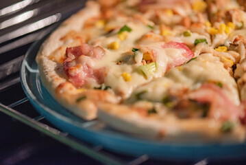 Pizza in a ceramic plate for serving. Pizza with chicken and bacon.