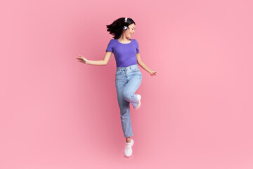 Enjoying Favorite Song. Full length of emotional excited asian woman wearing wireless headset...