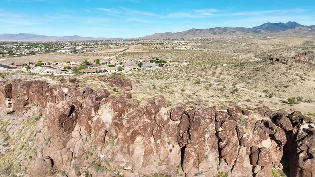 Aerial Tracking Shot Over Desert Cliffs and Small Town Edge Arizona