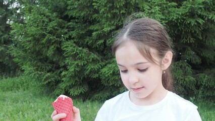 Portrait, young cute girl with ice cream in park, happy child outdoor with nature and freedom,...