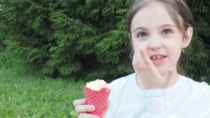 Portrait, young cute girl with ice cream in park, happy child outdoor with nature and freedom,...