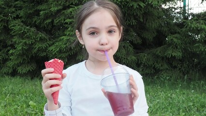 Portrait, young cute girl with ice cream in park, happy child outdoor with nature and freedom,...