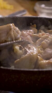 Cooking chicken and mushrooms with onions in pan on stove in kitchen enhances natural flavors. Perfect recipe idea for satisfying dinner or weekly meal plan