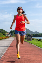 Young latin woman running in Panama city - stock photo