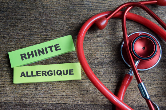 Concept of Rhinite allergique write on sticky notes isolated on Wooden Table.
