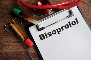 Concept of Bisoprolol write on clipboard isolated on Wooden Table.