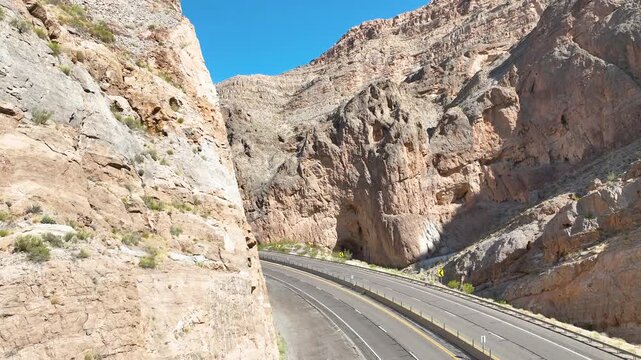 Aerial Pedestal Shot Winding Highway and Desert Cliffs Fly Over in Virgin River Gorge
