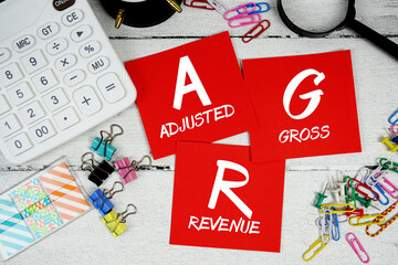 AGR abbreviation of Adjusted Gross Revenue text phrase of business and financial concept