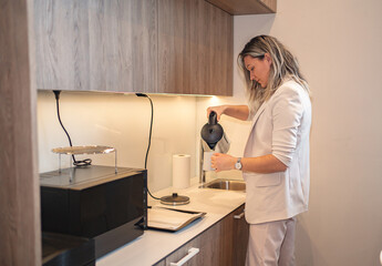 Woman Standing in Kitchen Next to Counter