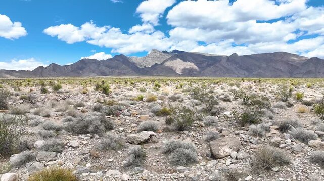 Aerial Desert Landscape Tracking Motion Over Rugged Mountains and Blue Sky