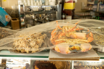 Fresh seafood including crab and shellfish on display inside a traditional Lisbon cafe.