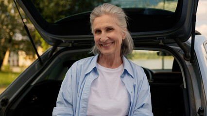 Happy retiree Caucasian senior elderly woman rental service dealership client auto buyer mature...