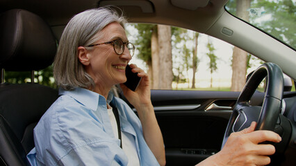 Happy satisfied laughing Caucasian grandmother female elderly senior mature woman taxi driver auto...