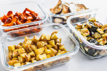 glass containers with meal prepped roasted sweet potato potato zucchini and eggplant for the week