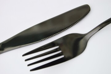 Sleek Black Cutlery Modern Fork and Knife on White Background Minimalist Kitchenware.