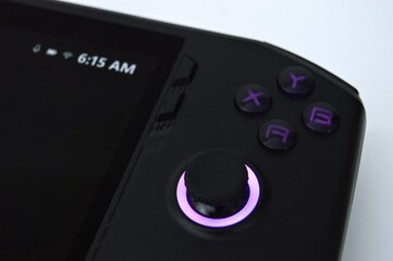 Sleek Black Handheld Gaming Console with Purple Accents CloseUp Detail.