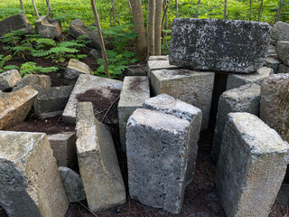 Pile of left over concrete block, concrete masonry blocks, messy arrangement, green trees surrounding