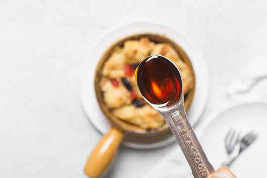 Golden syrup in a spoon, a tablespoon of golden syrup for baking, a spoon of light treacle