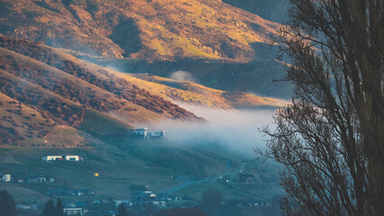 close up of hills folds with fog and clouds cromwell new zealand beautiful stunning