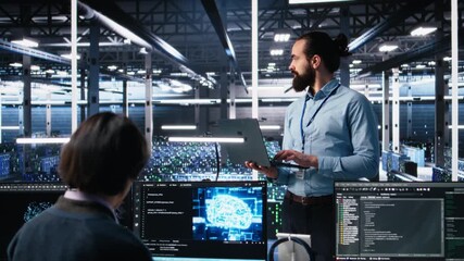 Data center technician using laptop to monitor neural network AI LLM visualization. IT specialist in high tech facility using notebook to oversee servers powering machine learning processes, camera A - Powered by Adobe
