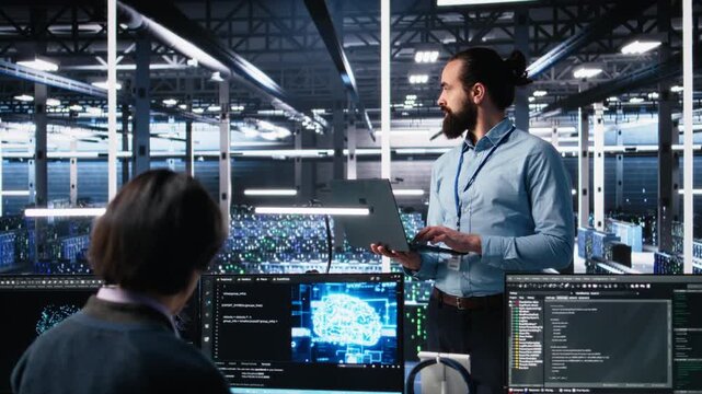 Data center technician using laptop to monitor neural network AI LLM visualization. IT specialist in high tech facility using notebook to oversee servers powering machine learning processes, camera A