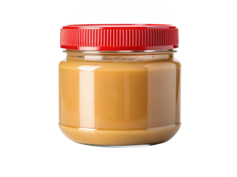 Glass jar of creamy peanut butter with a red lid isolated on transparent background