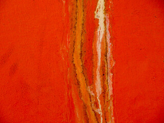 Red walls with flow water leaking stained marks over the paint.