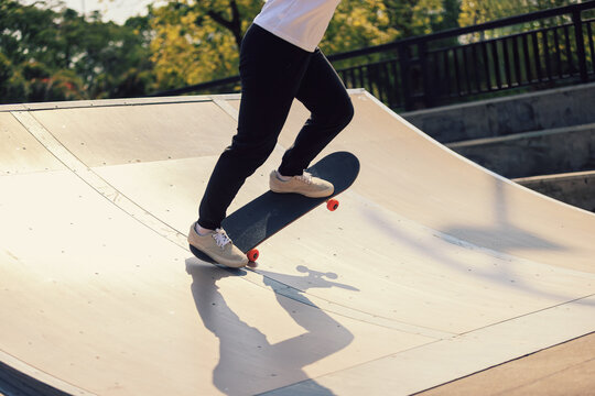 Skateboarder skateboarding at skatepark in city - Powered by Adobe