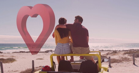 Sitting couple wearing outfits gazing toward horizon on beach with fence posts, shrubs, yellow jeep