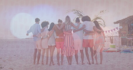 Standing friends linking arms facing ocean on sandy beach at sunset, with palm tree and bunting © vectorfusionart